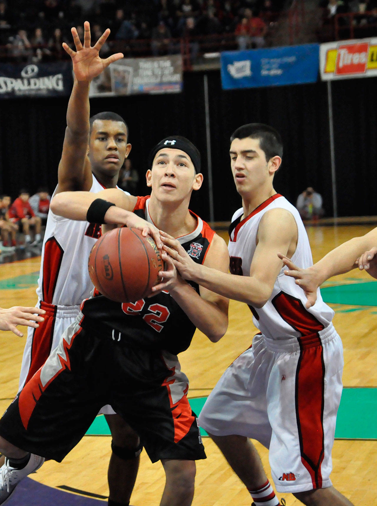 (Steve Rogers) Taholah’s Zach Cain works against Neah Bay’s defense during Wednesday night’s state 1B boys basketball loser-out game at Spokane Arena.