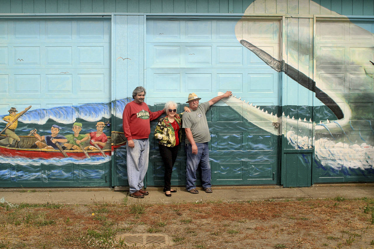 Ed Schroll | Associated Arts of Ocean Shores                                 Associated Arts of Ocean Shores members (from left) Michael Bedford, Joan Lohr and Jim Beauvais donated their talent and time painting a mural next to Moby Dick restaurant on Pt. Brown Avenue in Ocean Shores.