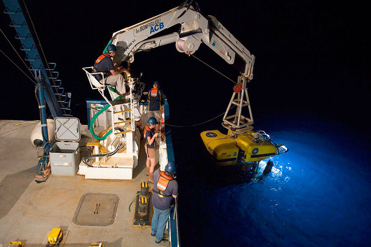 Ocean Exploration Trust photo                                Part of the crew of the research vessel Nautilus prepare to lower one of the ship’s two remote controlled vehicles for nighttime research. Live video of the Quinault Canyon research will be available at www.nautiluslive.org.