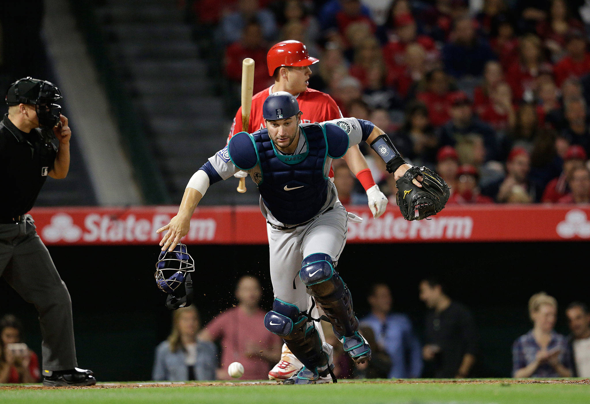 (Gina Ferazzi/Los Angeles Times) Seattle’s Mike Zunino, seen here chasing after a passed ball against Los Angeles, had a very big hitting month of June for the Mariners. Now pundits are asking whether Zunino or Ben Gamel had the better month for Seattle?