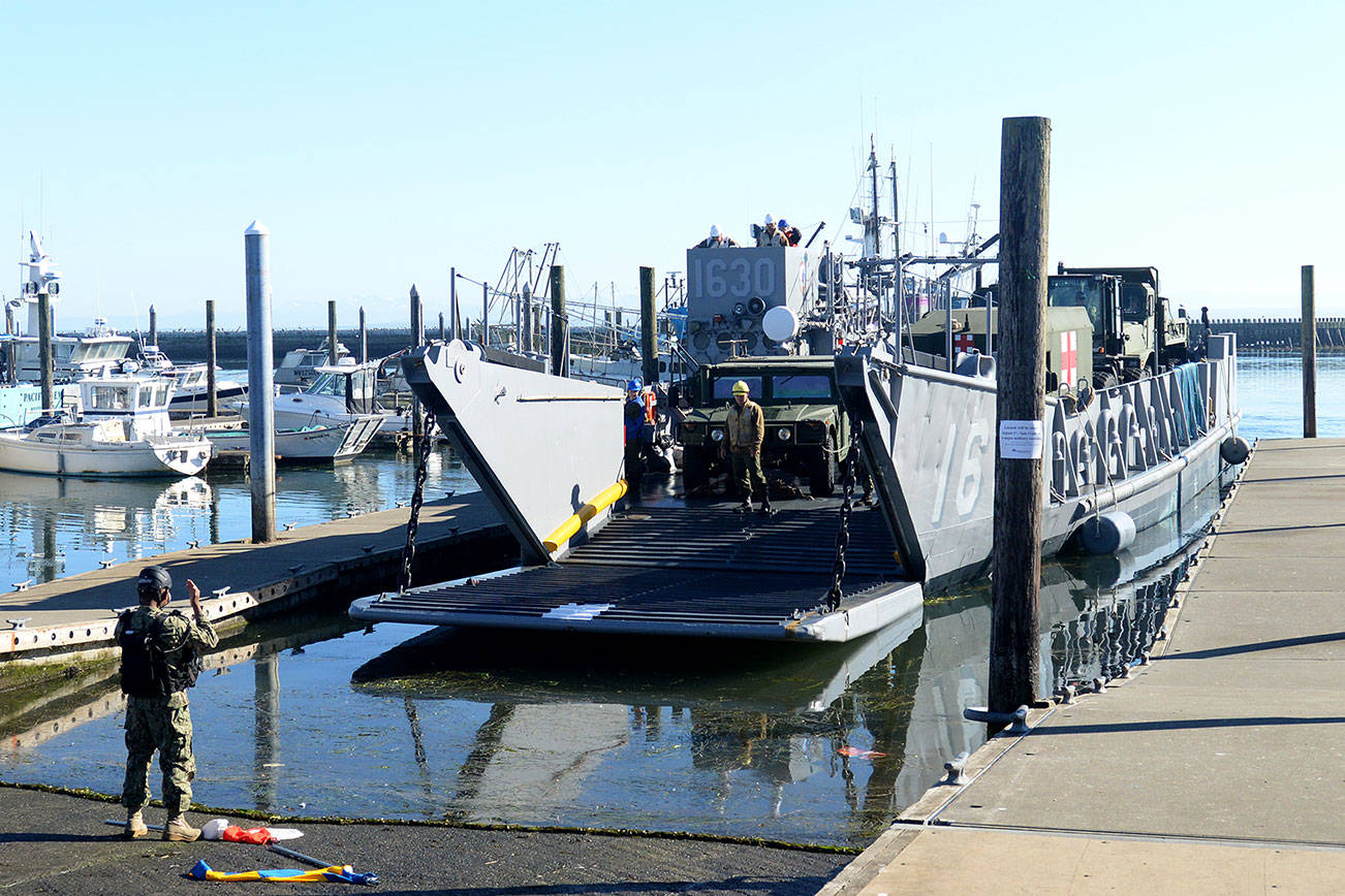 DAN HAMMOCK | THE DAILY WORLD                                The first vehicle to depart the landing vessel at the Westport Marina Tuesday morning was this armored Army Humvee. It was followed by an ambulance, and aid vehicle and a front end loader.