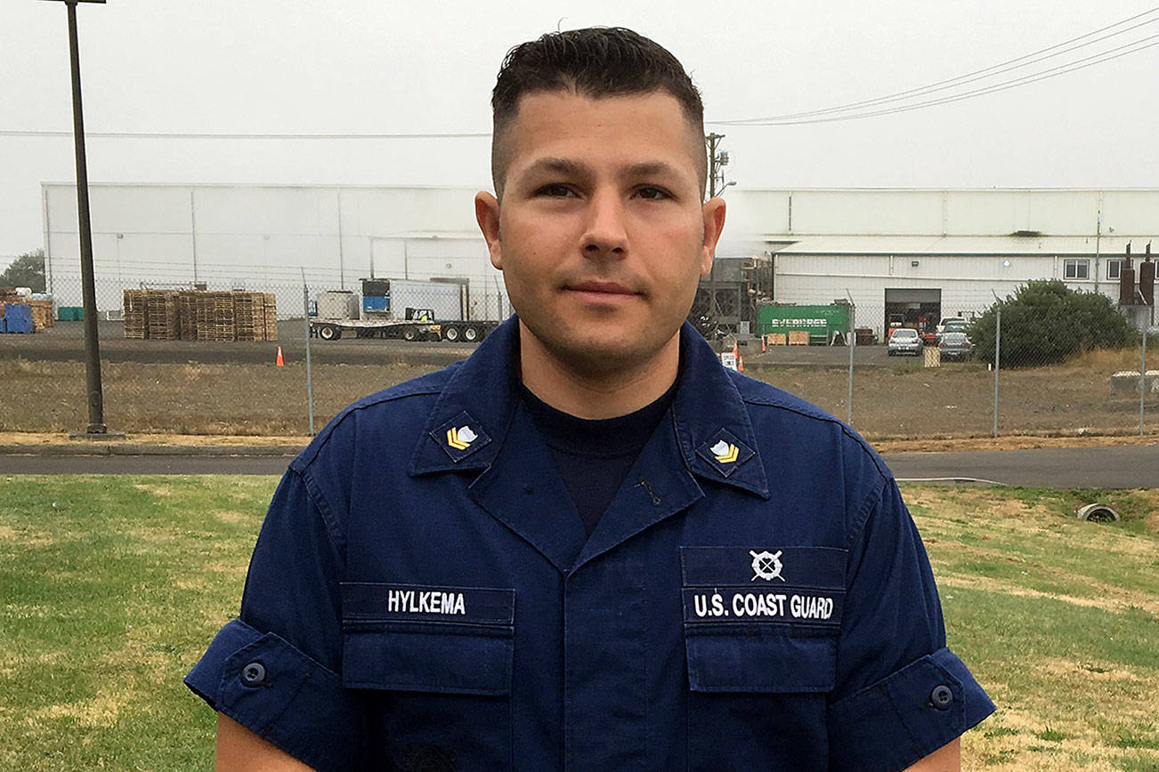 DAN HAMMOCK | THE DAILY WORLD                                Petty Officer 2nd Class Jacob M. Hylkema stands outside Coast Guard Station Grays Harbor in Westport. He will be awarded later this year for his heroism after diving into rough seas to rescue the captain of the sailing vessel Grace last October.