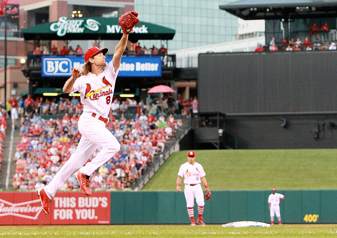 Pitcher Mike Leake catches the throw from first baseman Matt Carpenter and covers first on a ground out at Busch Stadium in St. Louis. The Mariners acquired Leake in a trade Wednesday.                                (Chris Lee/St. Louis Post-Dispatch)