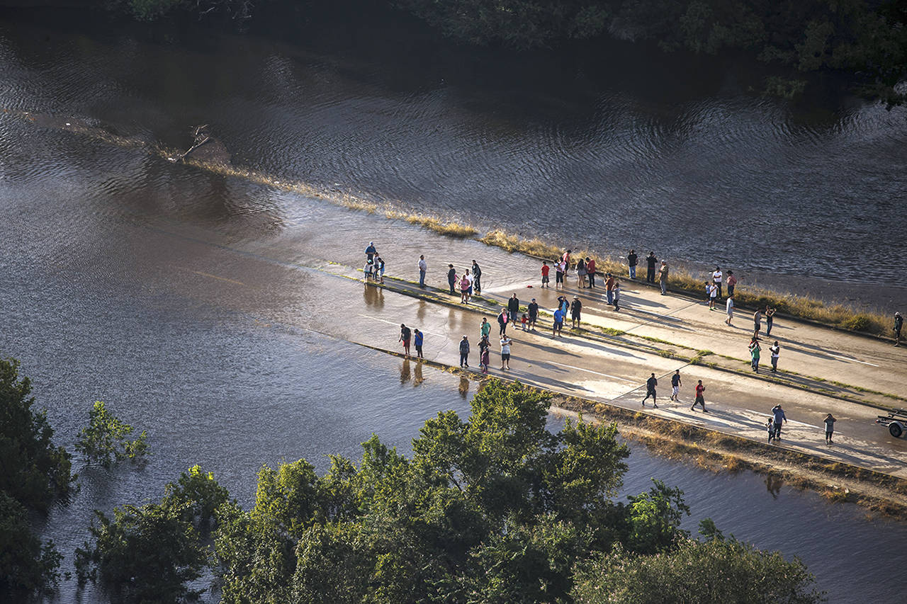 People come out to visit the flooded areas near their homes in Houston. (Marcus Yam | Los Angeles Times)