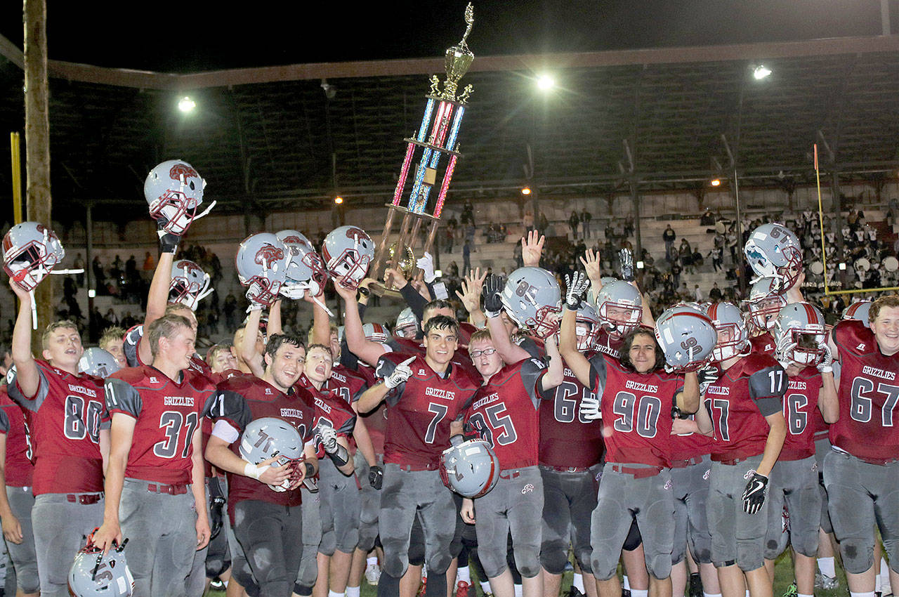 The Hoquiam Grizzlies celebrate their 14-12 victory over rival Aberdeen in the 112th meeting of the two teams on Friday night at Olympic Stadium. (Brendan Carl Photography)