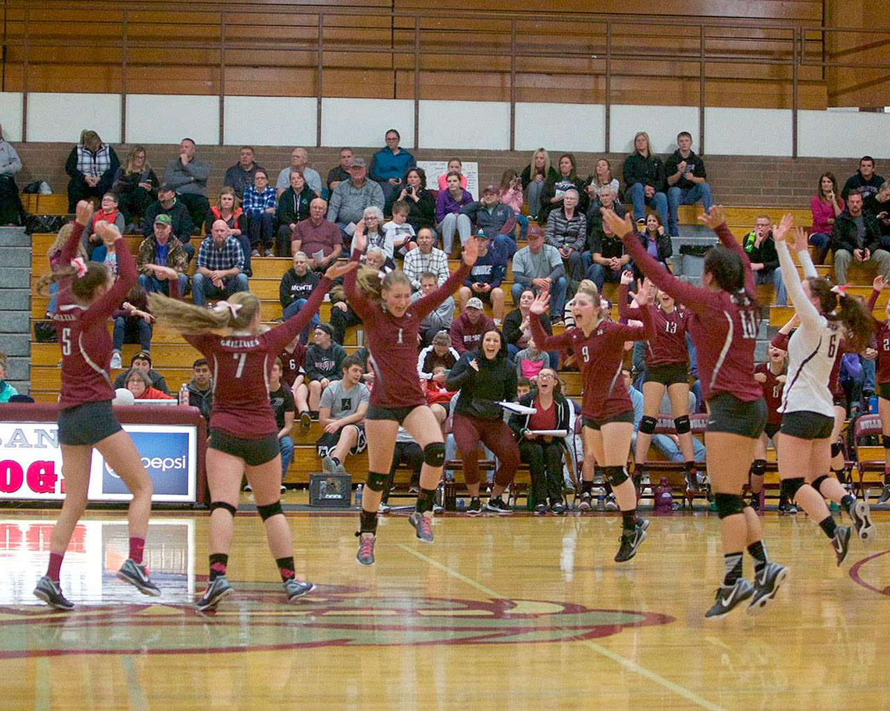 Photo by Patti Reynvaan — The Hoquiam volleyball team celebrates its four-game victory over rival Montesano on Thursday at Bo Griffith Memorial Gym.