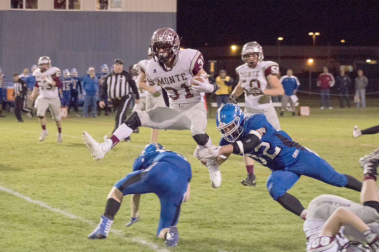 Montesano running back Carson Klinger hurdles an Elma defender during a 47-yard run on Friday night at Davis Field in Elma. The Bulldogs won the game, 51-0. (Brendan Carl Photography)