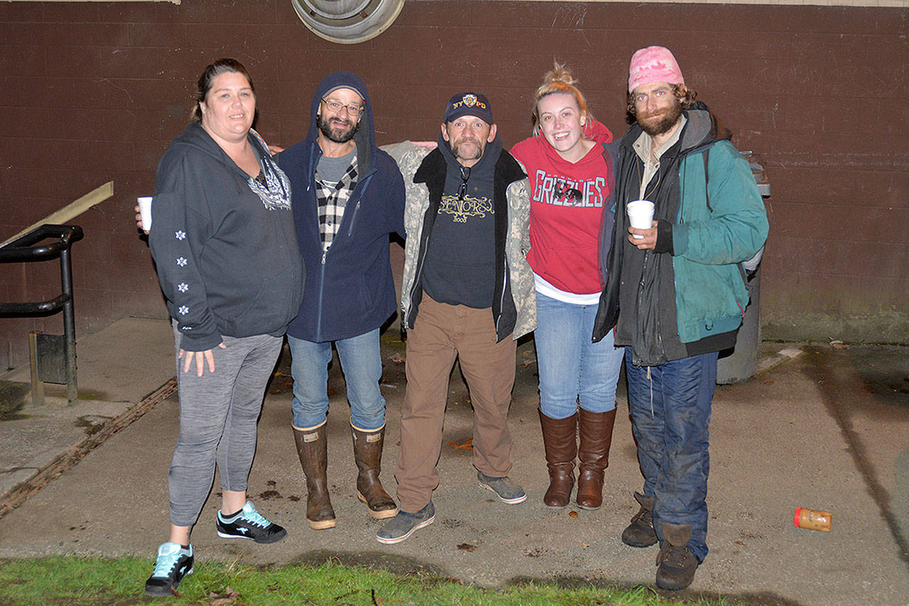 Revival of Grays Harbor founder Emily Reed (red jacket) stands with staff and homeless visitors at First United Methodist Church in Aberdeen. (Louis Krauss)