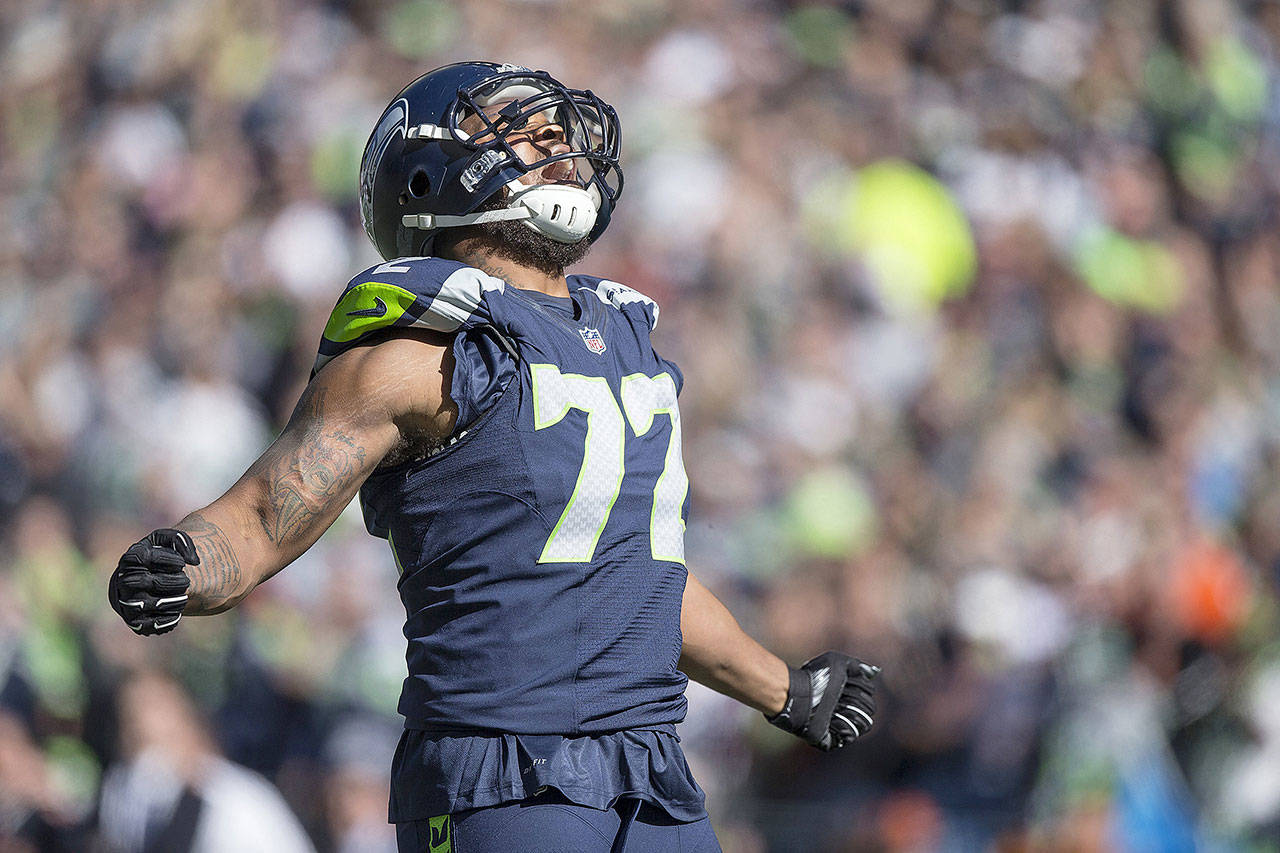 Seattle Seahawk Michael Bennett celebrates after a tackle for loss. (Dean Rutz/Seattle Times)