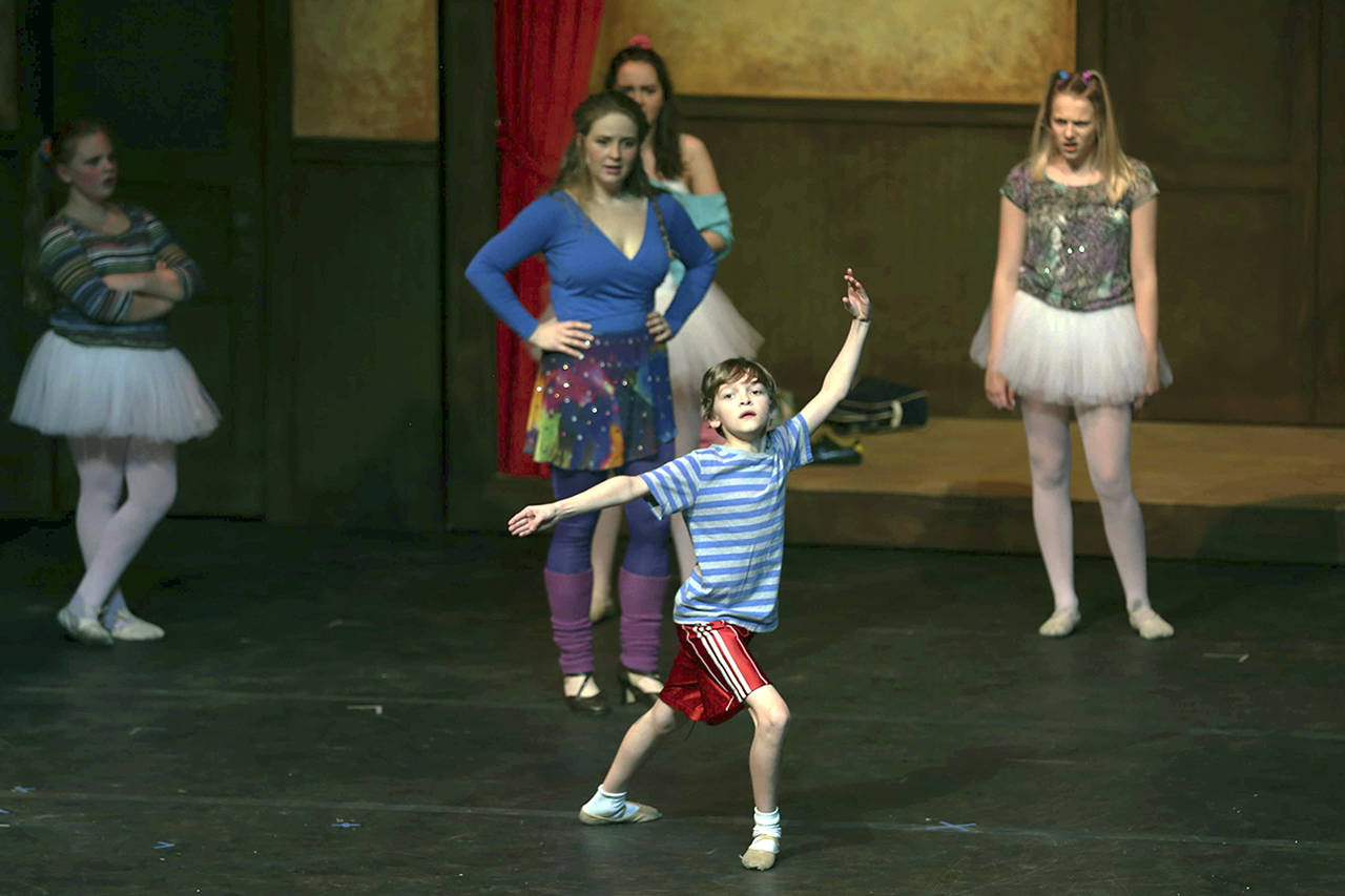 (Photo by Keith J. Krueger) Dance teacher Mrs. Wilkinson (Julayne Fleury, center) and other students look on as Billy (Justyce Brook) dances.