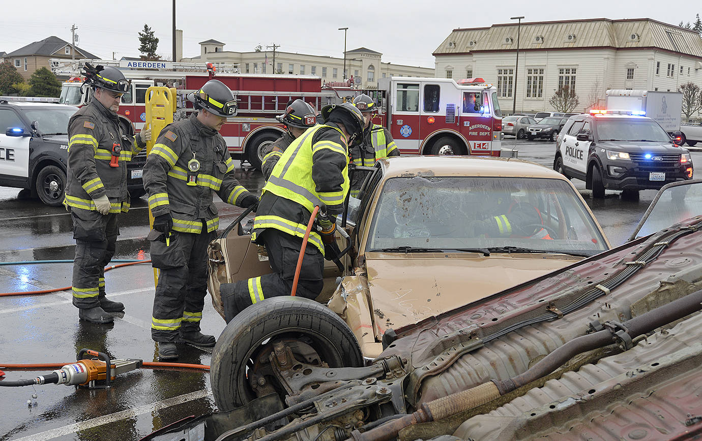 DAN HAMMOCK | THE DAILY WORLD                                Members of the Aberdeen Fire Department use the Jaws of Life to extricate a student playing a critically injured passenger.