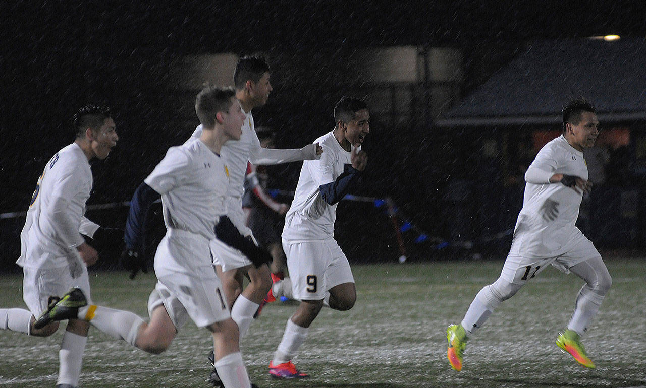 Aberdeen’s Hulizes Chavez, No. 9 in center, celebrates with his teammates after scoring the game-winning goal against Hoquiam on Thursday night at rain-swept Stewart Field. (Hasani Grayson | The Daily World)