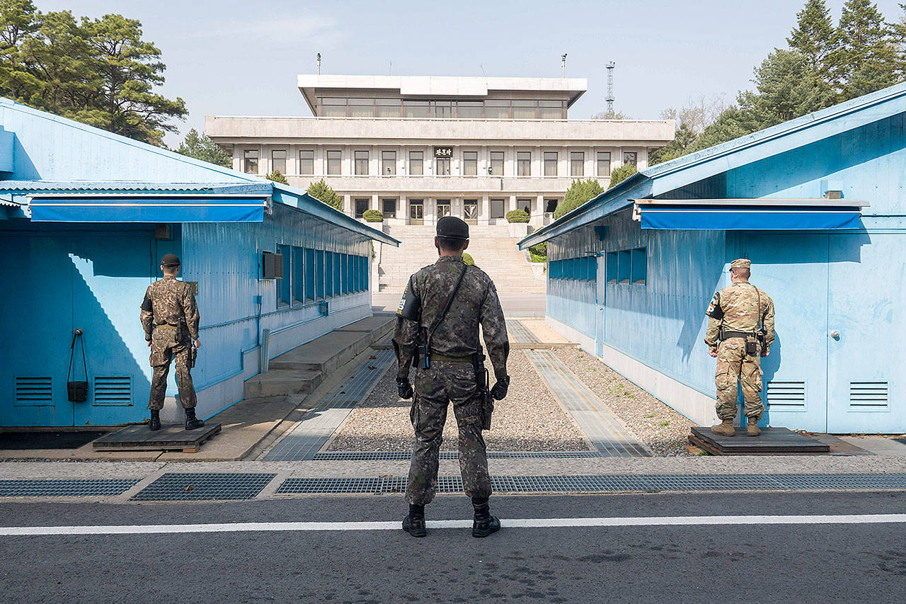 On April 18, 2018, in Paju, South Korea, South Korean soldiers and a U.S. army soldier, right, keep watch on North Korea at the truce village of Panmunjom in the demilitarized zone (DMZ) separating North Korea from the South. (Lee Jae-Won/AFLO)