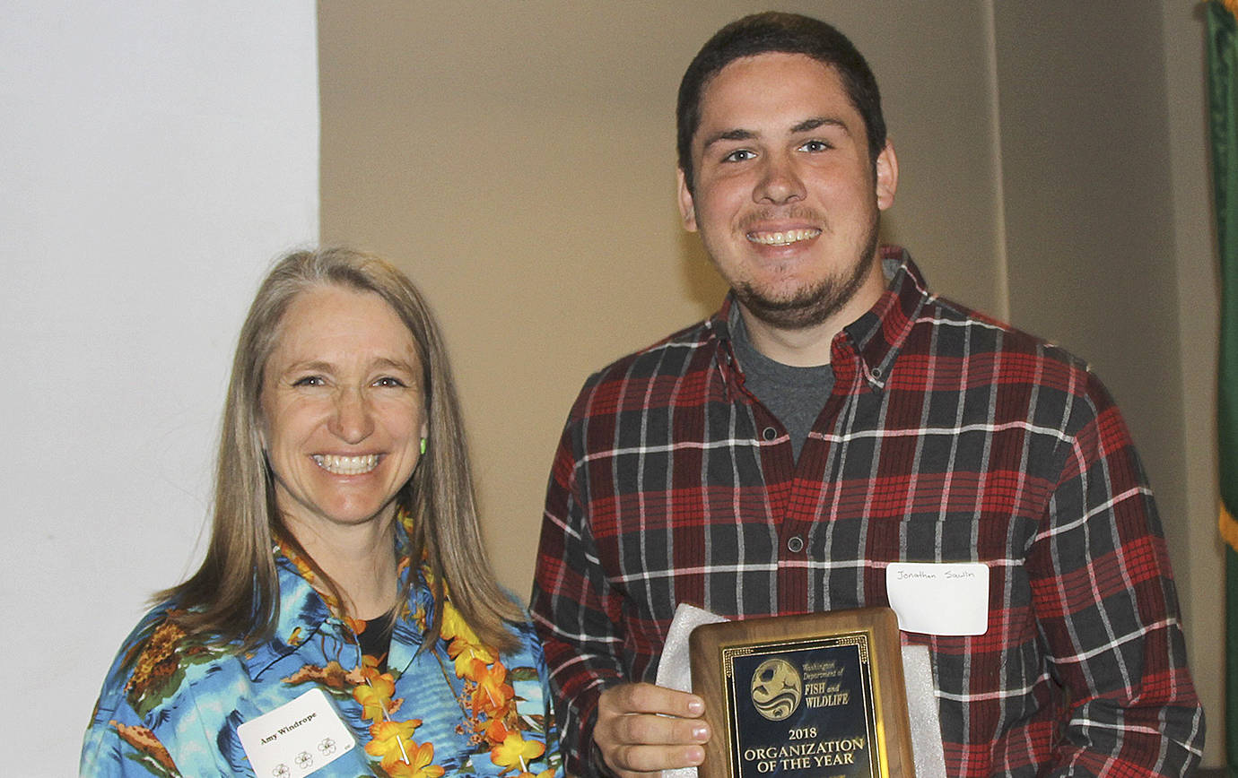 PHOTO COURTESY STATE DEPARTMENT OF FISH AND WILDLIFE                                Jonathan Sawin, captain of the charter boat &lt;em&gt;Cormorant&lt;/em&gt; out of Westport Charters, accepts the State Department of Fish and Wildlifes Organization of the Year award from the departments deputy director Amy Windrope at a ceremony May 16. Sawin accepted on behalf of the Westport Charterboat Association for their salmon monitoring efforts.