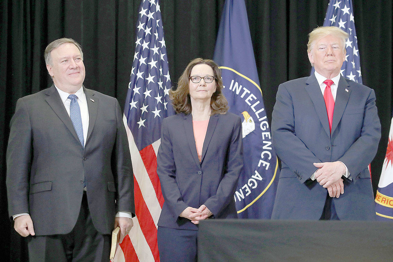 U.S. Secretary of State Mike Pompeo, Gina Haspel and President Donald Trump attend the swearing-in ceremony for Haspel as CIA director at agency headquarters Monday in Langley, Virginia. Last week the Senate confirmed Haspel to replaced Mike Pompeo, who was sworn in as Secretary of State earlier this month. (Mark Wilson/TNS)