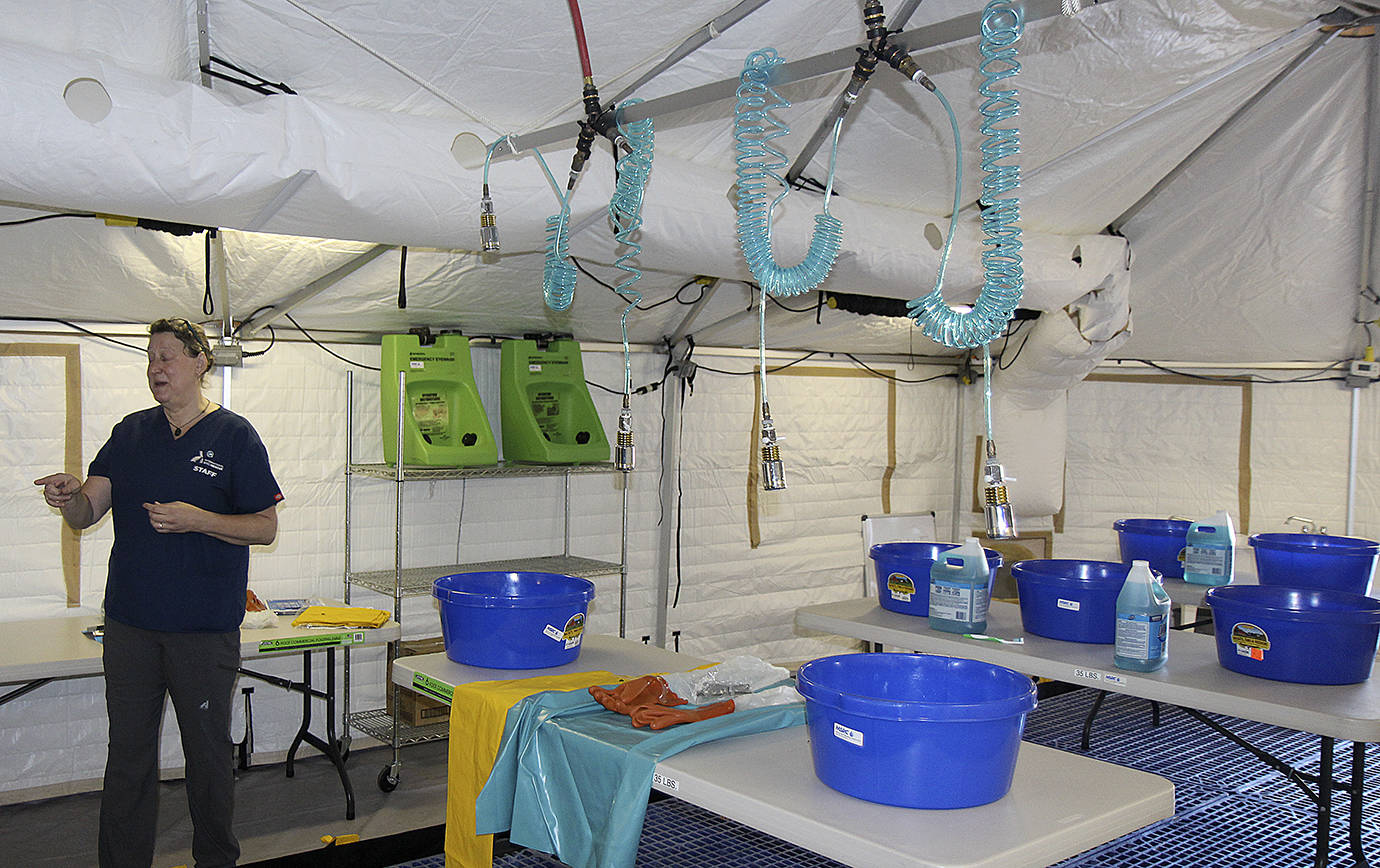 DAN HAMMOCK | THE Daily World                                Michelle Bellizzi with International Bird Rescue describes the wash room, where oiled birds are taken for a good scrubbing after they have been checked in, assessed and stabilized.