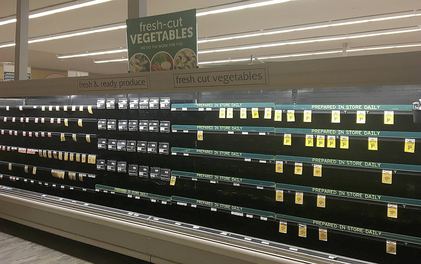 DAN HAMMOCK | THE DAILY WORLD                                The fresh produce section of Safeway, which normally handles bagged salad, dressings and vegetables, was stripped bare Tuesday morning after the store lost refrigeration through at least early afternoon.