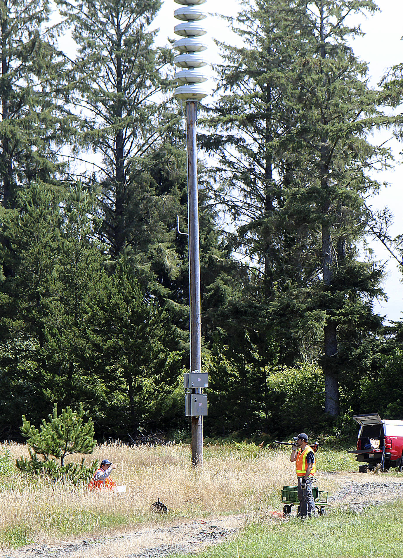 DAN HAMMOCK | THE DAILY WORLD                                Crews with the Department of Natural Resources test the ground near the southernmost tsunami siren on the Shoalwater Bay Indian Reservation July 18. This is the location chosen for the vertical tsunami evacuation tower, close to tribal housing.