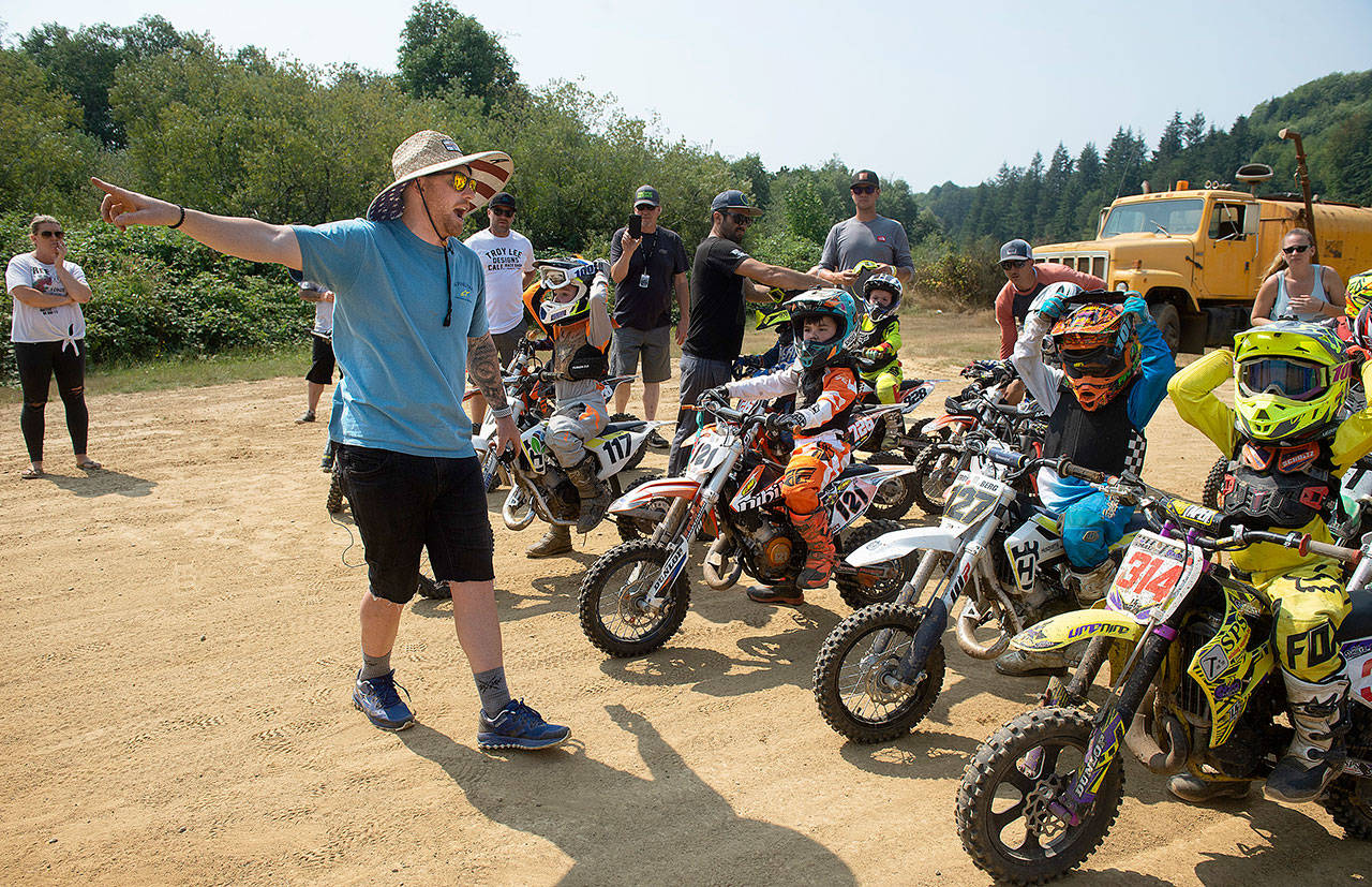 Ten-time national motorcross and supercross champion Ryan Villopoto offers tips to student riders on traversing the obstacles of the new arenacross course during the second-annual RV2 Summer Camp at Grays Harbor ORV Park on Monday, Aug. 13, 2018. (Tony Overman | The Olympian)