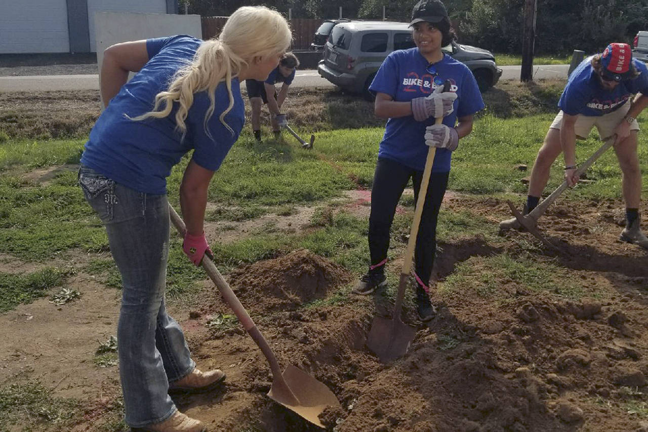 (Courtesy photo) Miss Grays Harbor Kuinn Karaffa, left, a Habitat for Humanity board member, works with Alyssa Peguero, a member of the Bike & Build group.