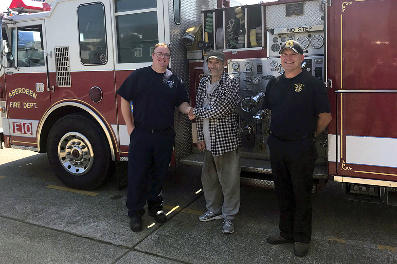 Photo courtesy Aberdeen Fire Department                                From left, Aberdeen Fire Department paramedic Colby Raffelson shakes hands with Gary Vaughan as Battalion Chief Damon Lillybridge looks on.