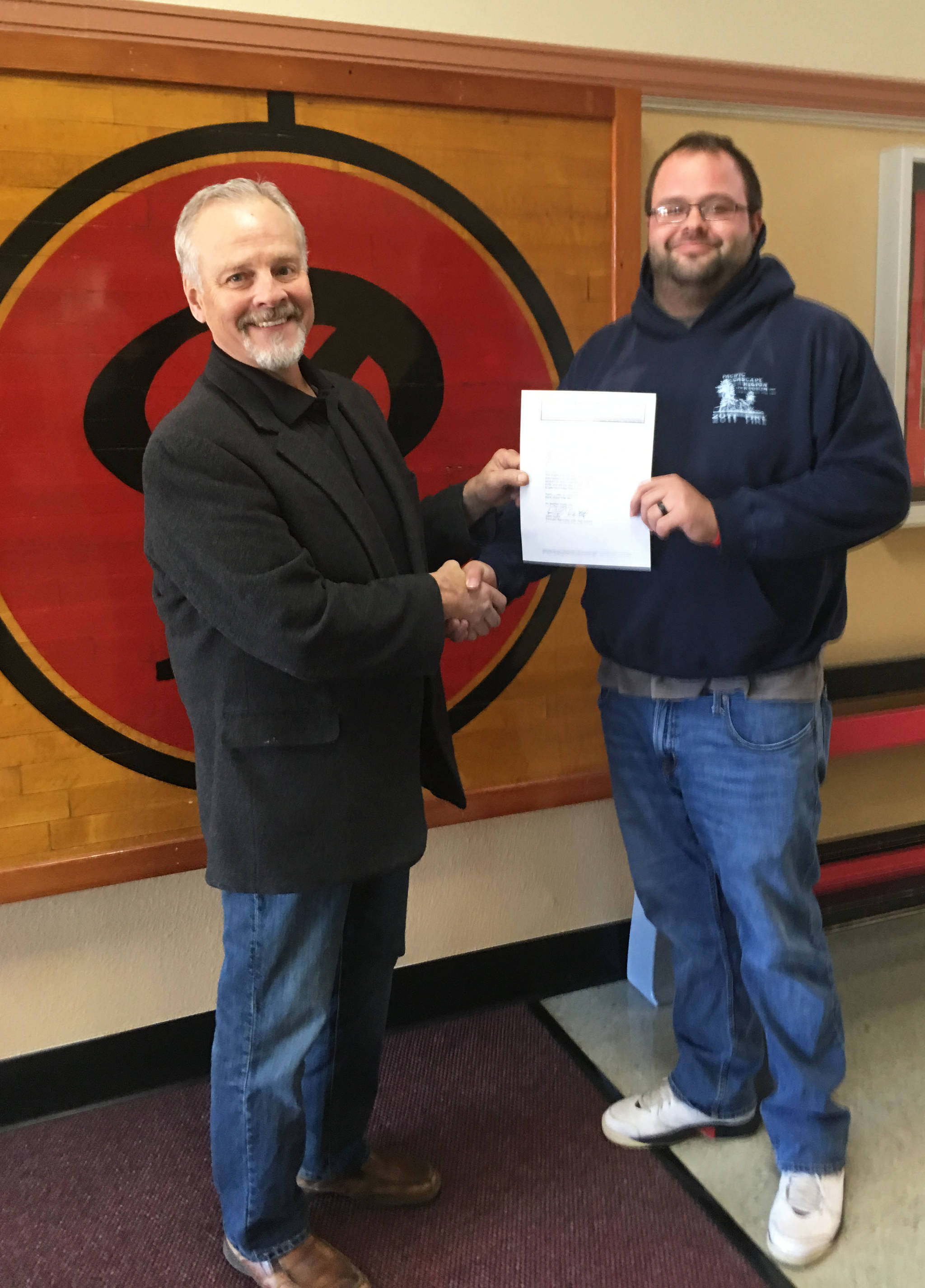 Photo courtesy Dave Vetter                                 Raymond Junior High Principal Dave Vetter, left, presents his letter of commendation to para-professional Ethan Gusdal.