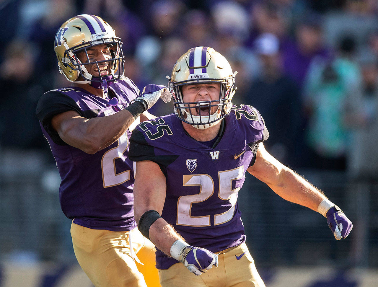 Washington’s Ben Burr-Kirven, right, celebrates an interception against Colorado with teammate Keith Taylor on Saturday, Oct. 20, 2018. Burr-Kirven was awarded as the Pac-12’s defensive player of the year on Tuesday. (Dean Rutz/Seattle Times/TNS)