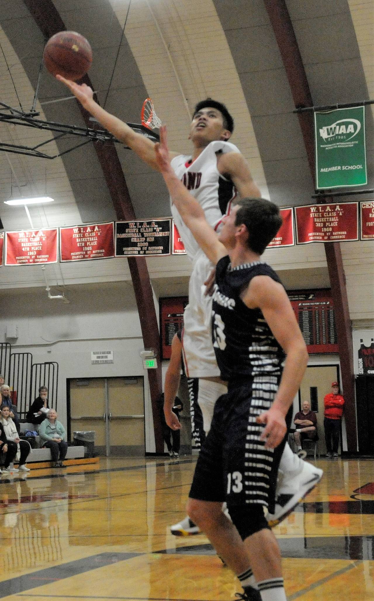 Raymond’s Devin Souvannavanh hits a shot over Pe Ell’s Carson Cox on Saturday. Souvannavanh scored 13 points in Raymond’s 70-48 victory. (Hasani Grayson | Grays Harbor News Group)