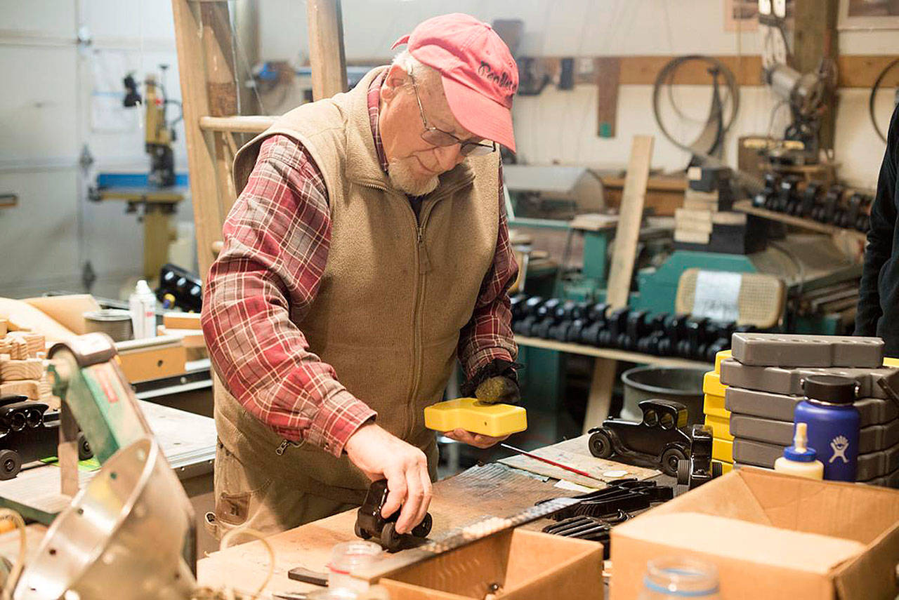 Caption: Don Powell make final touches on a toy truck that he built in his Oakville shop.                                 (Katie Hayes | The Chronicle)