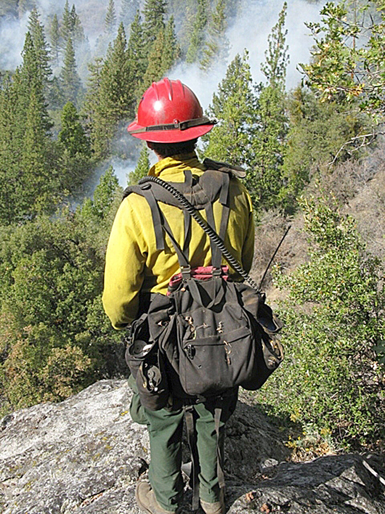 A crew member monitors a prescribed burn at Yosemite National Park. Fire helps recycle important nutrients back into the soil and makes way for new grasses, wildflowers and other plants. (National Park Service file photo)