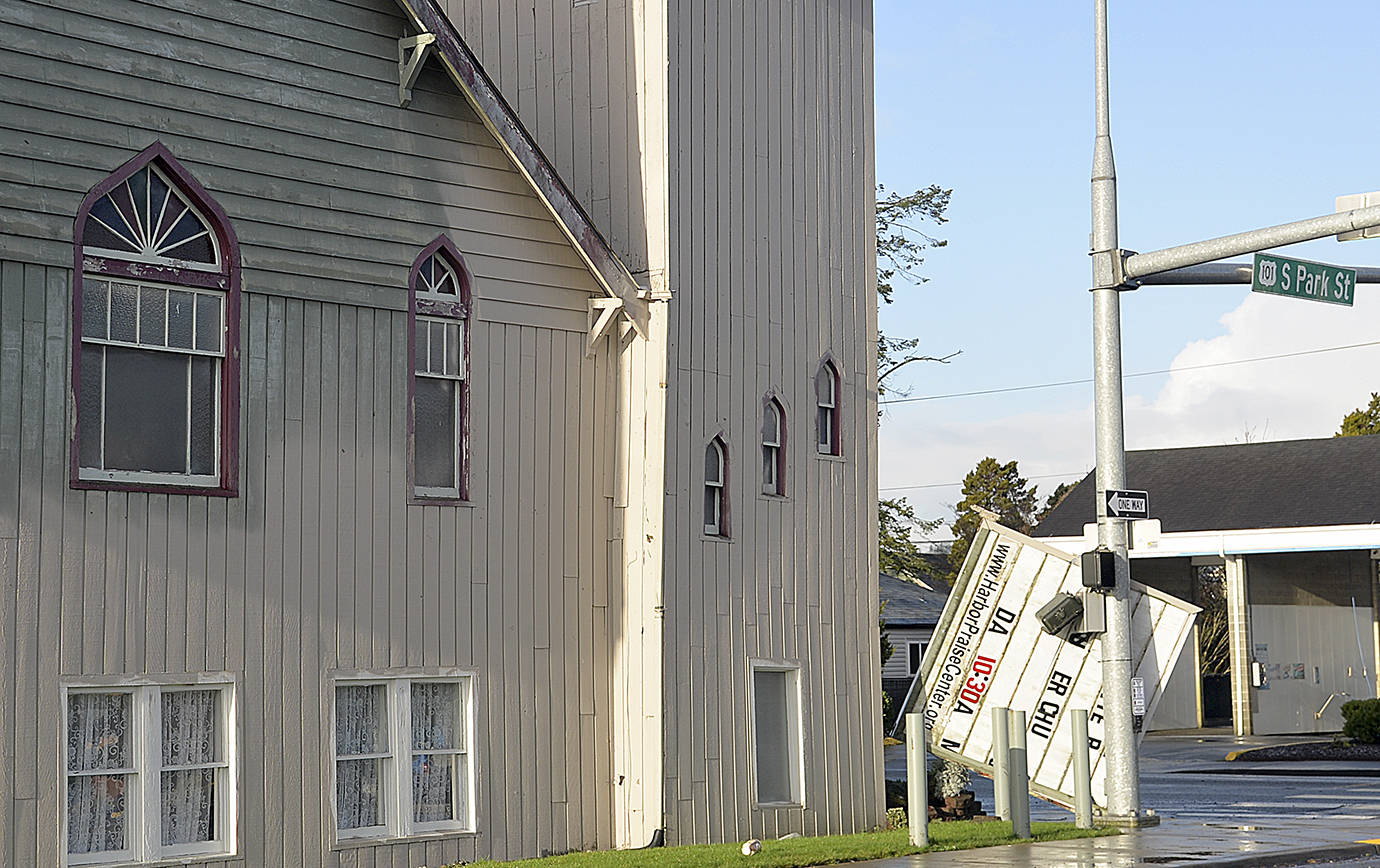 DAN HAMMOCK | GRAYS HARBOR NEWS GROUP                                Strong winds knocked the sign off the Harbor Praise Center at the corner of West Wishkah and South Park streets in Aberdeen Sunday morning. Monday morning the traffic light at the intersection was still blinking and the crosswalk signals were disabled.