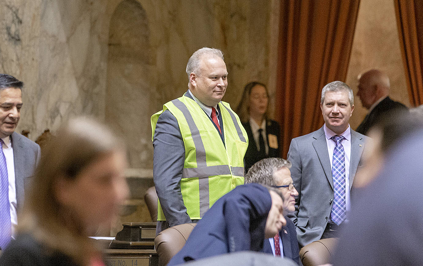 COURTESY LEGISLATIVE PHOTOGRAPHY                                Rep. Jim Walsh, R-Aberdeen, donned a yellow safety vest ahead of Gov. Jay Inslee’s State of the State Address Tuesday to protest the Governor’s proposed carbon tax.