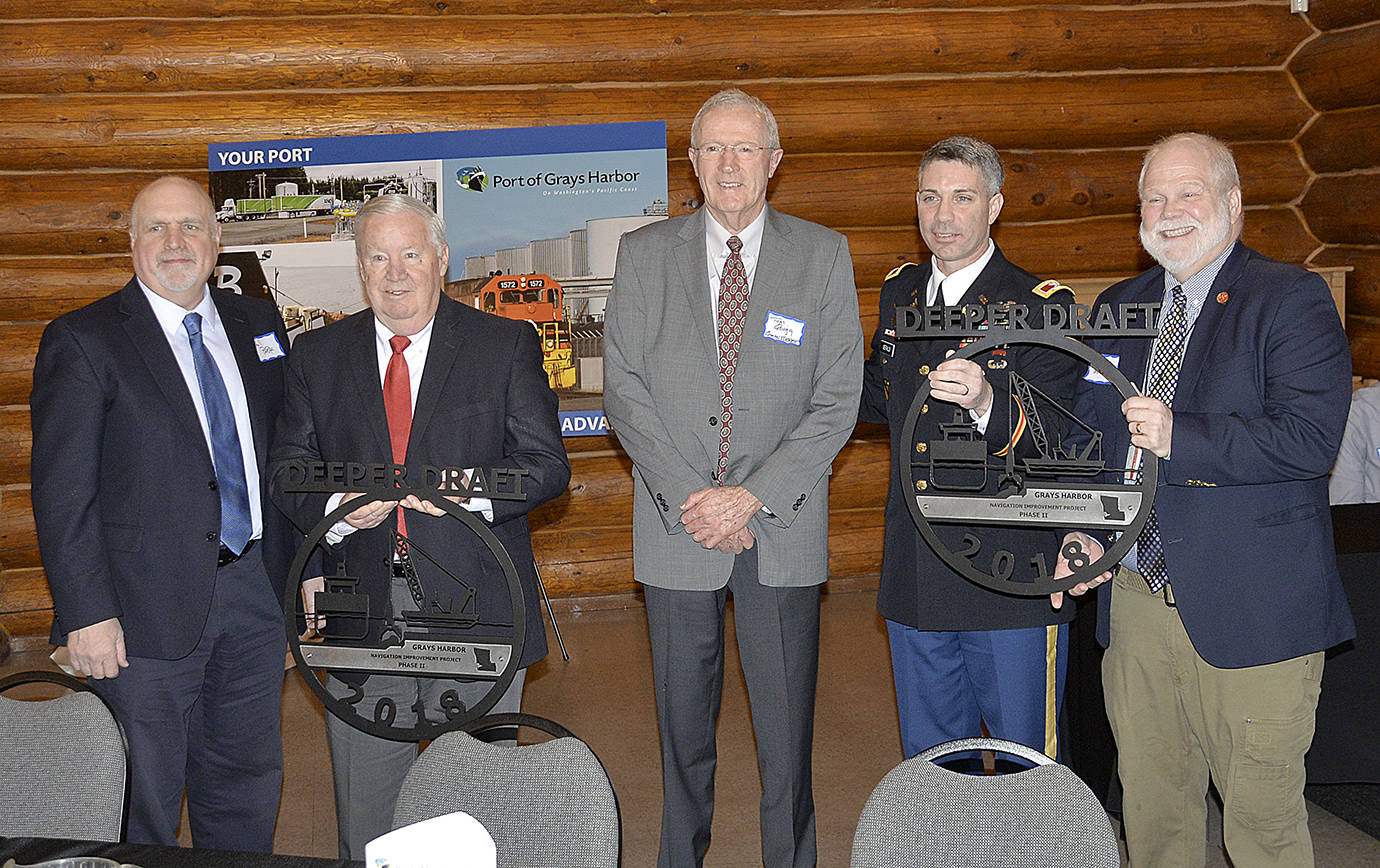 DAN HAMMOCK | GRAYS HARBOR NEWS GROUP                                From left, Port of Grays Harbor commissioners Phil Papac, Stan Pinnick and Tom Quigg and Army Corps of Engineers representatives Col. Mark A. Geraldi and Army Corps Navigation Chief John Hicks show off the metal sculptures given as part of the celebration of the Deeper Draft Phase II dredging project completion Wednesday morning.