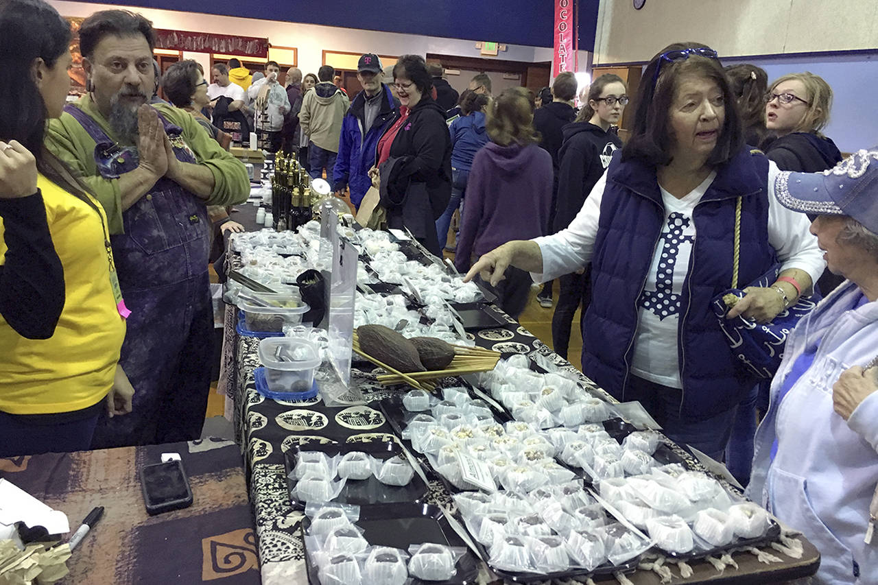 (Kat Bryant | Grays Harbor News Group) Olympia-based chocolatier Brother Bliss oversees his Blissful Wunders booth as visitors check out his handmade truffles on Saturday at the Chocolate on the Beach festival in Pacific Beach.