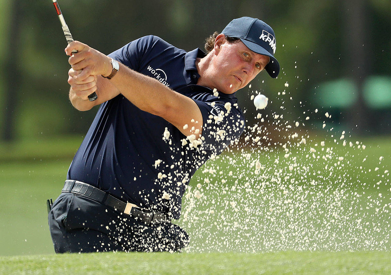 Phil Mickelson hits out of a bunker on the 17th hole during the second round of the Masters Tournament on Friday, April 12, 2019, at Augusta National Golf Club in Augusta, Ga. (Jason Getz/Atlanta Journal-Constitution/TNS)