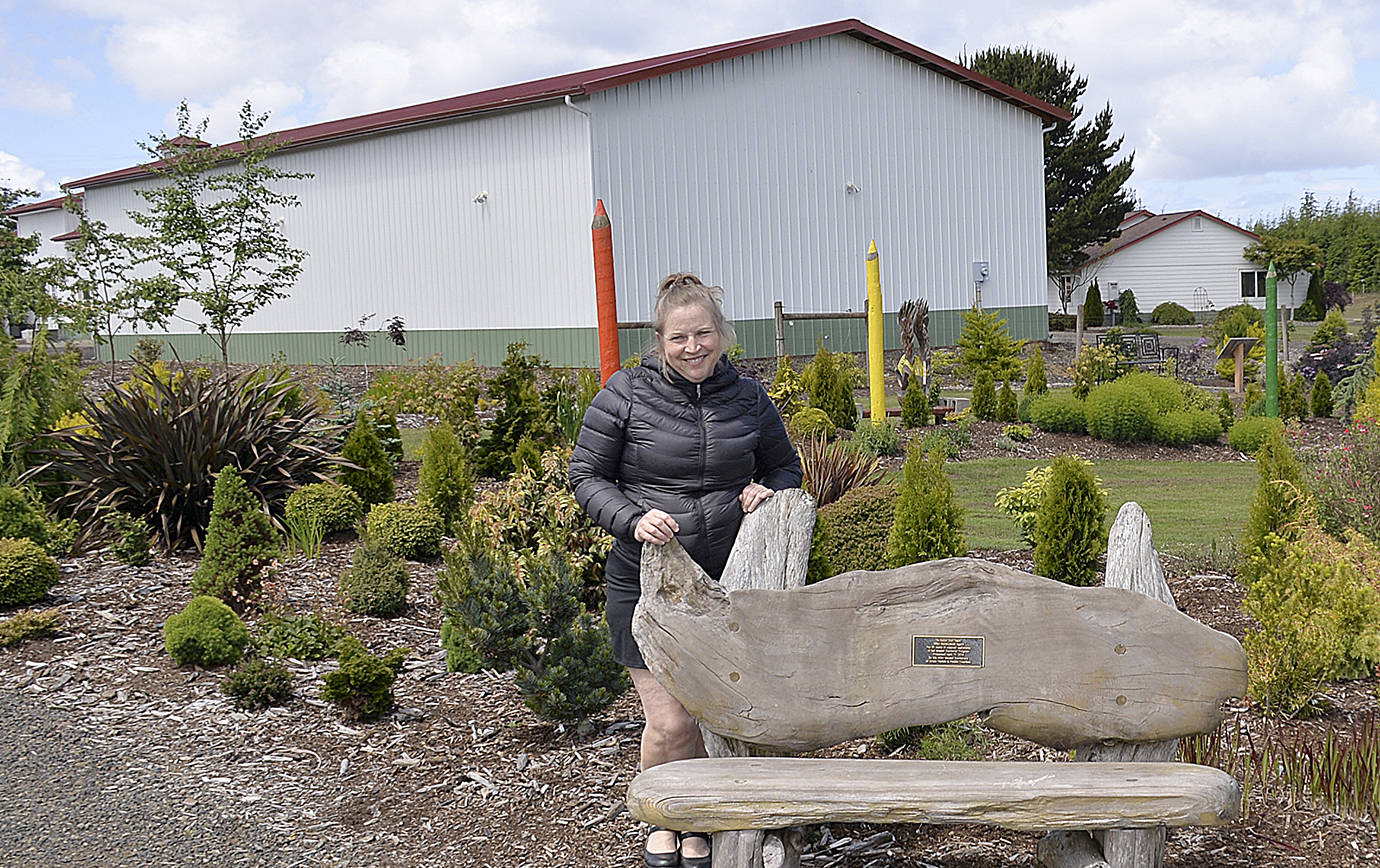 DAN HAMMOCK | GRAYS HARBOR NEWS GROUP                                Kim Roberts stands on the grounds of the Westport Winery. Behind her is the building that will hold the craft distillery she and her family are hoping to have up and running this fall.