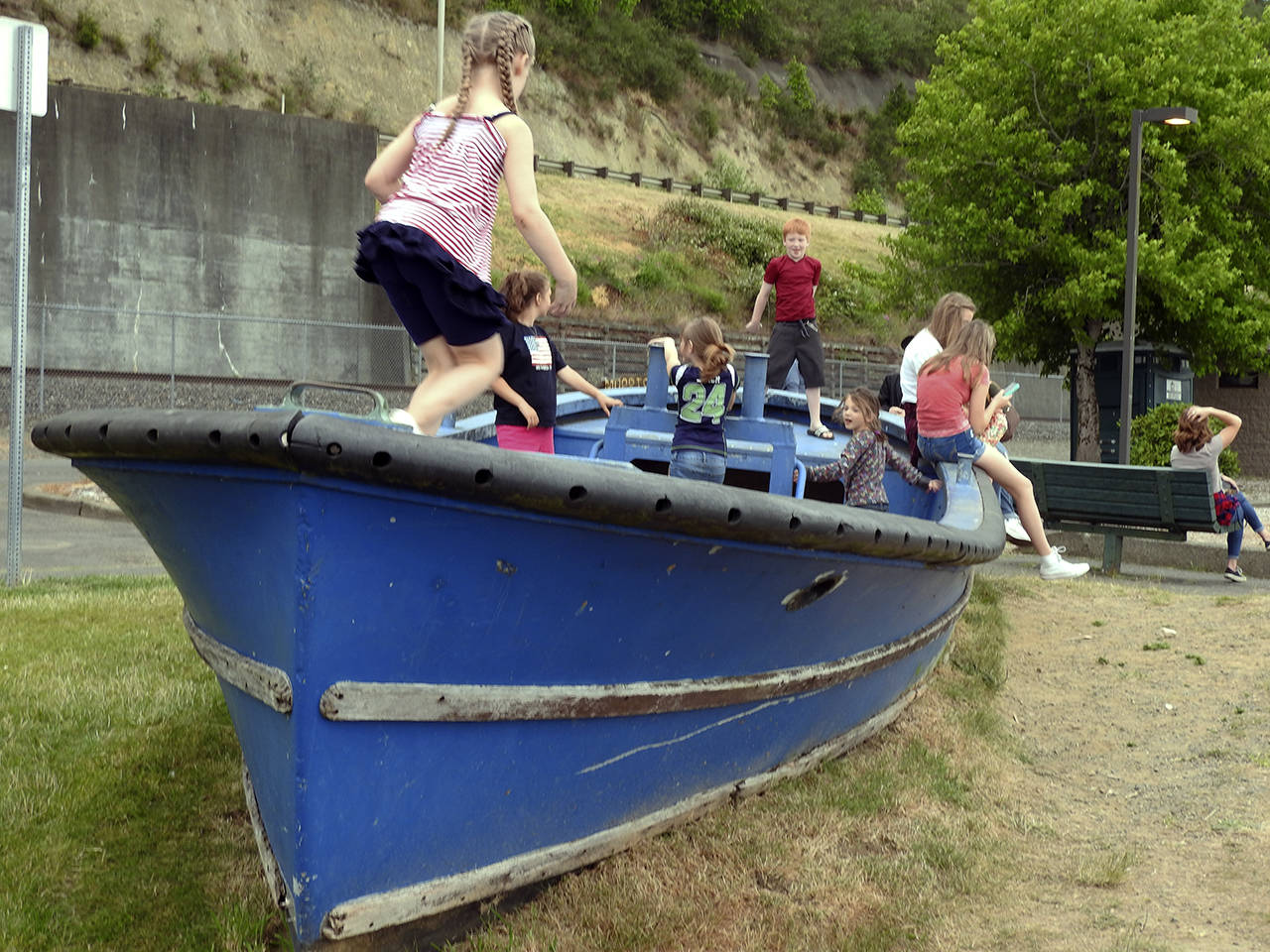 (Kat Bryant | Grays Harbor News Group) Some kids play in a boat at Morrison Riverfront Park during Splash Festival 2018.