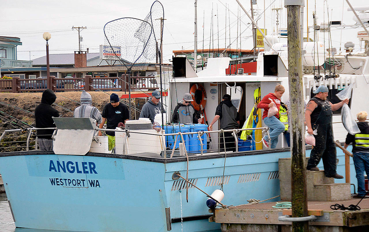 Anglers disembark the Westport charterboat Angler after a combination trip with sacks of salmon and bottomfish filets. (DAN HAMMOCK | GRAYS HARBOR NEWS GROUP)