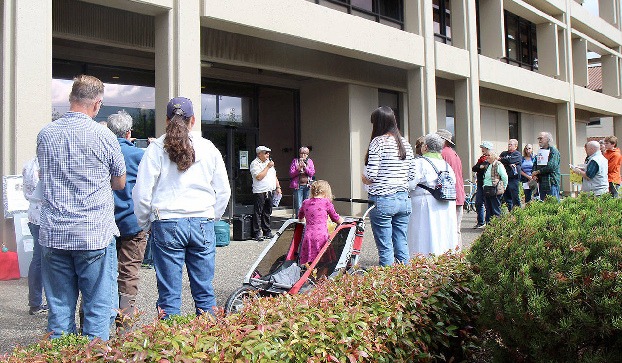 Pastor Ele Garcia of Montesano United Methodist Church speaks to the crowd gathered Friday, Sept. 20, in front of the county administration building as part of a climate protest in Montesano. (Michael Lang | Grays Harbor News Group)