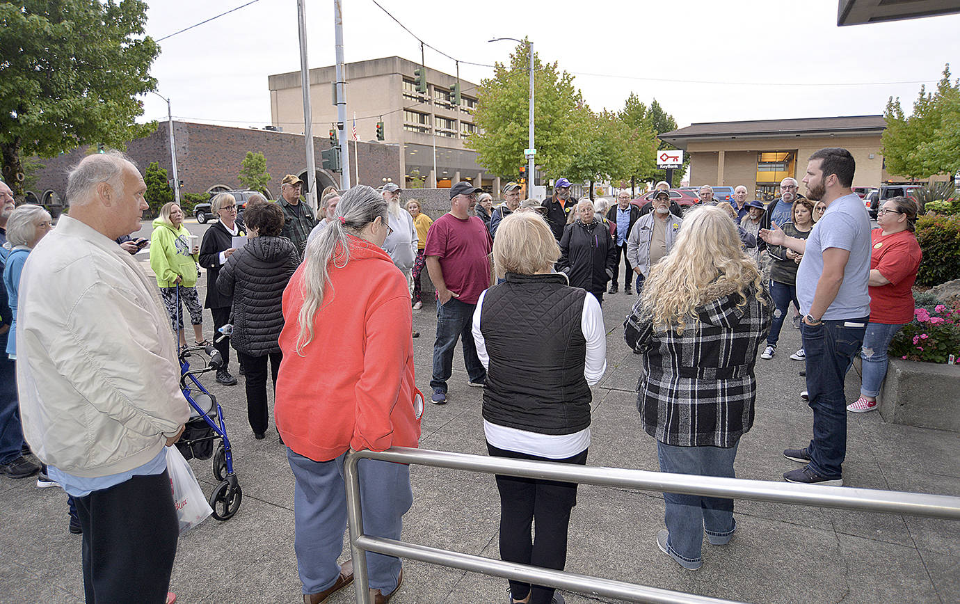 DAN HAMMOCK | GRAYS HARBOR NEWS GROUP                                Aberdeen Mayor Erik Larson, at right, invites the about 50 community members who showed up at City Hall Wednesday evening for a rally in opposition of a new longer-term homeless encampment on South Michigan Street to come up to City Council chambers to have their questions answered and comments heard.