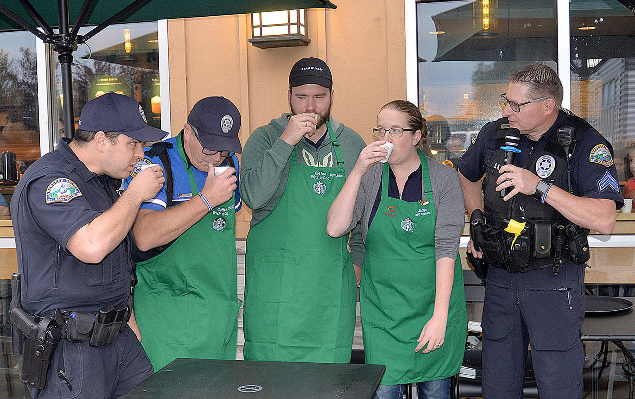 Photos by DAN HAMMOCK | GRAYS HARBOR NEWS GROUP                                The espresso shot challenge proved more challenging than the participants expected. From left are Aberdeen Police Officers Cody Blodgett and George Kelly, Aberdeen Mayor Erik Larson, and Starbucks Manager Jaclyn Meeks. Kelly downed his the fastest. At right is Police Sgt. Darrin King, who emceed the event.