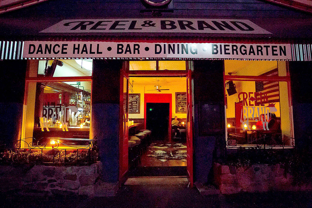 Patrons sit at candle-lit tables at Reel and Brand in Sonoma, Calif., on Oct. 9, during a planned power outage by the Pacific Gas & Electric utility company. (Brittany Hosea-Small/Getty Images)