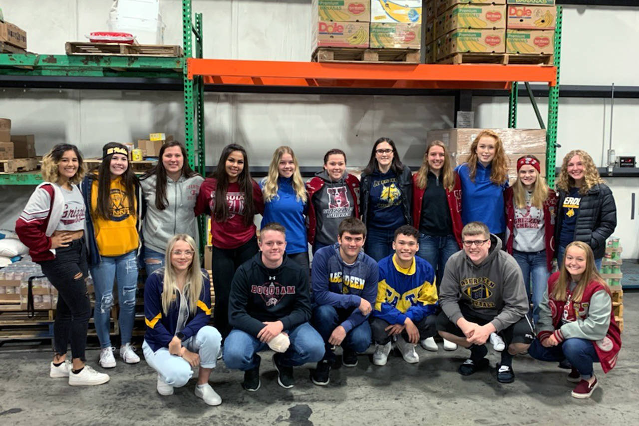 Courtesy photo                                This year’s Food Ball chairs and other volunteers from Aberdeen and Hoquiam high schools smile for the camera at Coastal Harvest on Monday. Two weeks of food collections and fundraising will begin Nov. 1.