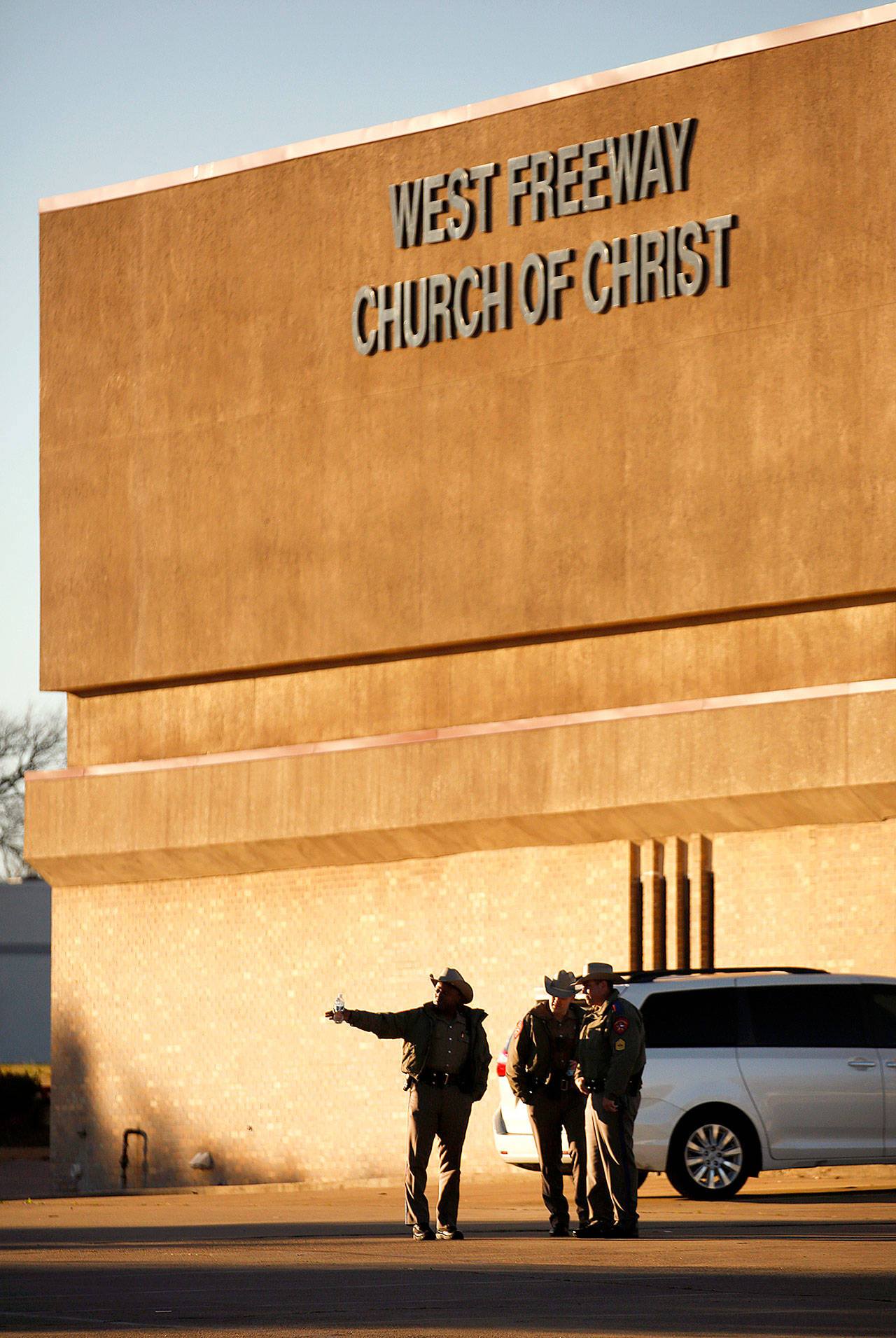 Texas Department of Public Safety troopers secure the parking lot before church and community members gathered outside the West Freeway Church of Christ in Fort Worth for a candlelight vigil Monday evening. A gunman shot and killed two parishioners before an armed security officer returned fire, killing him yesterday during their service. (Tom Fox/The Dallas Morning News)