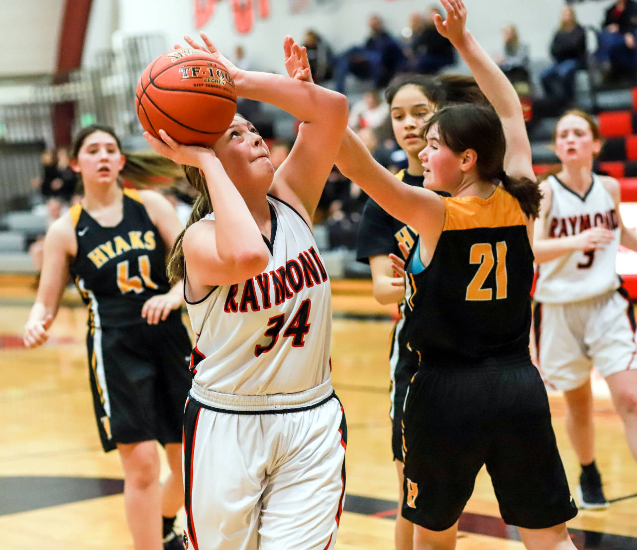 Raymond’s Hannah Miller (34) works to get up a shot against North Beach defenders Malia Cox (21) and Letty Carcaise (41) during the Seagulls’ 79-25 win on Monday in Raymond. (Photo by Larry Bale)