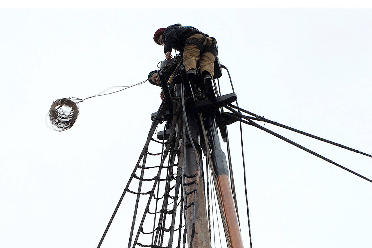 Kate Fournier and Bridget McCutchen swaying up the topgallant more than 50 feet above the deck of the Lady Washington on Thursday. (Thorin Sprandel | Grays Harbor News Group)