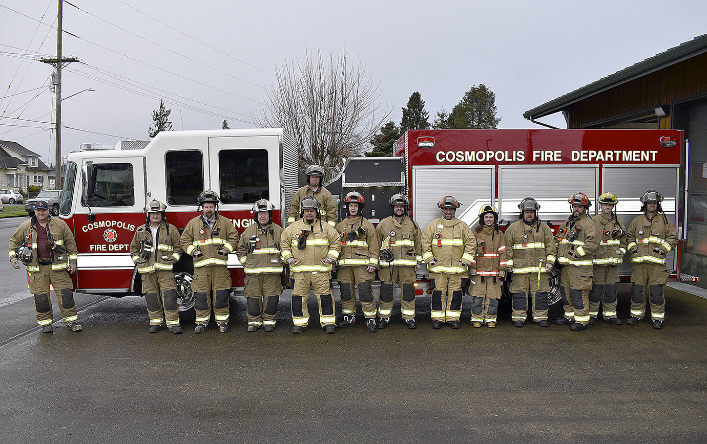 DAN HAMMOCK | GRAYS HARBOR NEWS GROUP                                 Cosmopolis firefighters pose with the department’s new fire engine, unveiled Sunday morning.