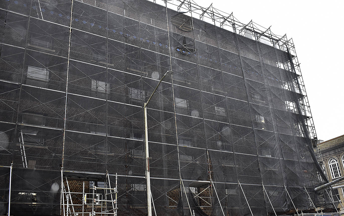 DAN HAMMOCK | GRAYS HARBOR NEWS GROUP                                 The scaffolding and sheeting hiding the brick exterior of Emerson Manor in Hoquiam started coming down Feb. 5 as a major renovation project reaches its conclusion.