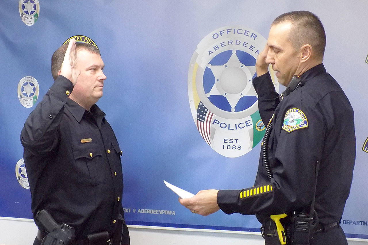 Aberdeen Police Chief Steve Shumate swears in newly promoted Police Commander Dale Green on Wednesday. (Courtesy Aberdeen Police Police Department)