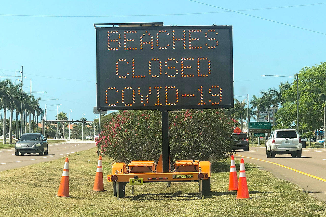 An electronic sign near St. Petersburg, Florida, after beaches in that region were closed over the weekend due to large crowds gathering there. (Dirk Shadd/Tampa Bay Times)